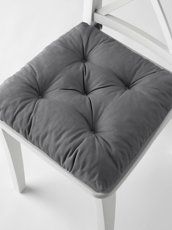 Gray seat cushion on white farmhouse decor style chair. 