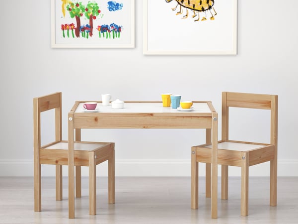 Kid furniture including kids dining room set & picture frames holding their artwork. 