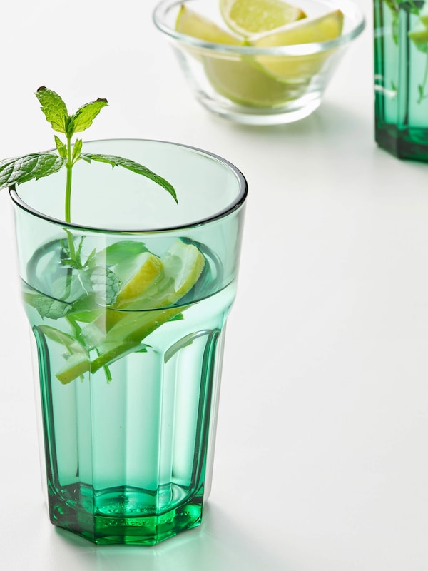 Light green glassware holding a refreshing summer drink. 