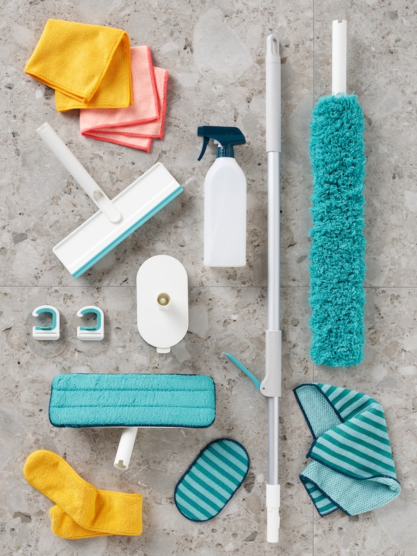 PEPPRIG microfiber cloths, a PEPPRIG spray bottle and the parts of a PEPPRIG cleaning set spread out on a stone-tiled floor.