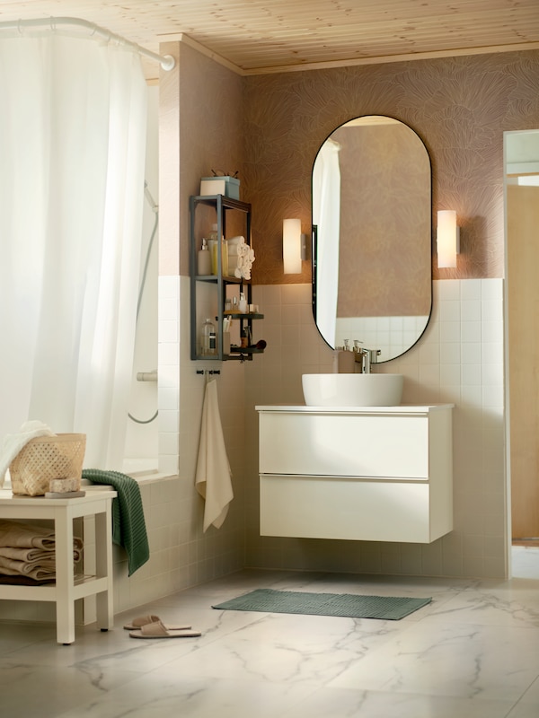 A bathroom in contemporary style with floors in marble effect, white tiles, a GODMORGON wash-stand and a LINDBYN mirror.