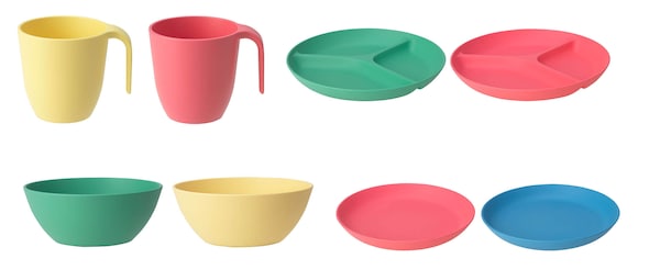 Several green, yellow, pink, and blue bowls, plates, and cups from the HEROISK series lined up against a white background.