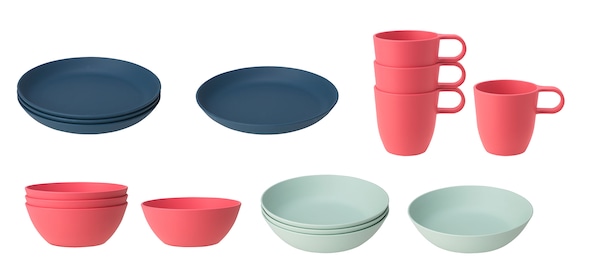 Stacks of dark blue plates, pink bowls and mugs, and light green bowls from the TALRIKA series against a white background.