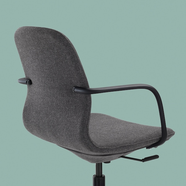 The back, side and seat of a LÅNGFJÄLL office chair with armrests in dark grey and black against a light teal background.