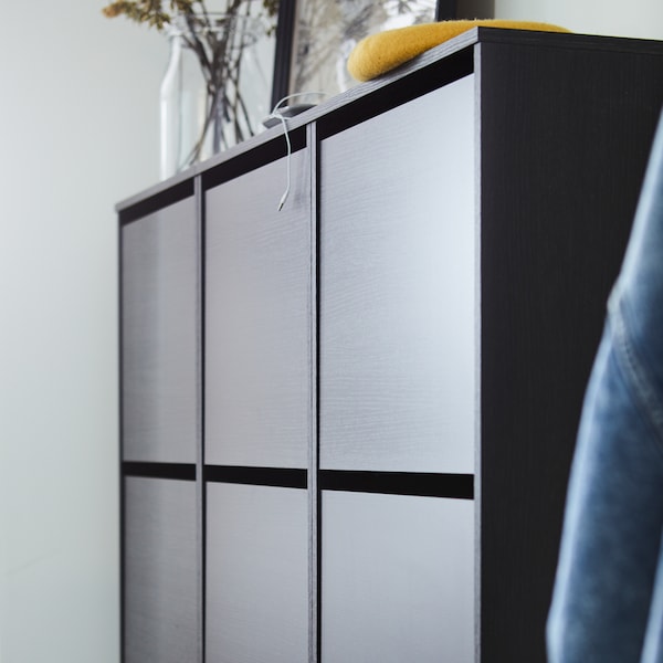 Three black/brown BISSA shoe cabinets with three compartments are mounted to the wall in a hallway.